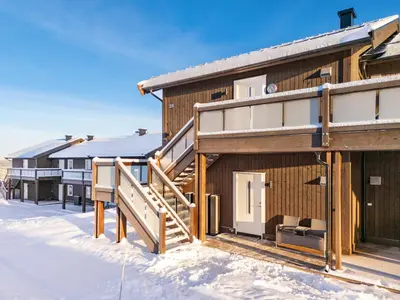 a house with a deck in the snow at Leilighet på Bualie, Golsfjellet in Gol