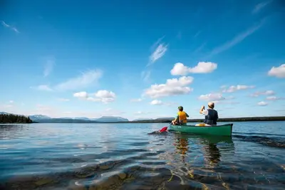 two people sitting in a canoe on a lake at Leilighet på Bualie, Golsfjellet in Gol