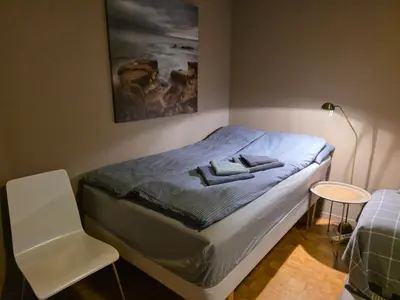 a bedroom with a bed with two towels on it at Rom 6 sentralt i Sogndal in Sogndal