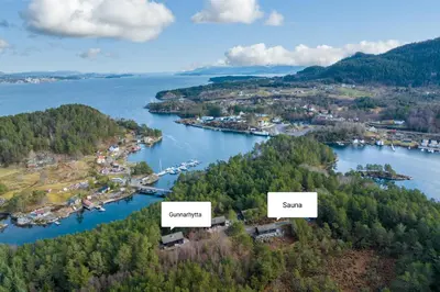arial view of a river with trees and a town at Gunnarhytta, Valevåg in Valevåg