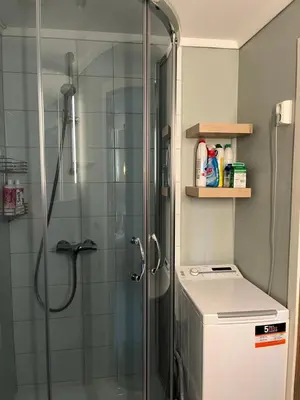 a shower in a bathroom with a glass shower stall at Flott Leilighet i stølen oppdal for 6 personer, ski in, ski out in Oppdal