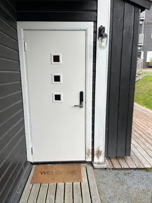 a white door on the side of a house at Flott Leilighet i stølen oppdal for 6 personer, ski in, ski out in Oppdal