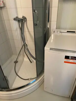 a shower with a glass door next to a toilet at Flott Leilighet i stølen oppdal for 6 personer, ski in, ski out in Oppdal