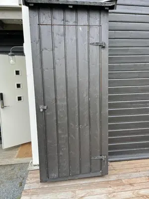 a metal garage door on the side of a building at Flott Leilighet i stølen oppdal for 6 personer, ski in, ski out in Oppdal