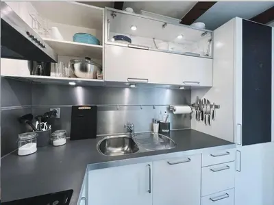 a kitchen with white cabinets and a sink at Apartment with Loft & Window Balcony, Free parking in Bergen