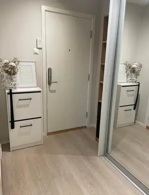 a mirror in a room with a door and a closet at Plaza Havstad in Trondheim