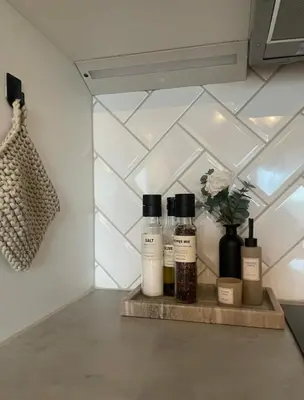 a shelf with three bottles of essential oils on it at Plaza Havstad in Trondheim