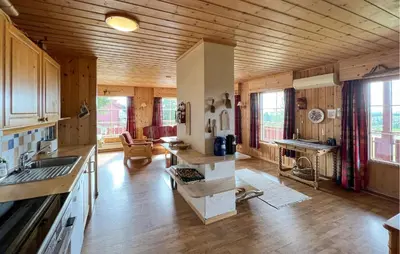 a kitchen with wooden walls and wooden flooring in a house at Nice Home In Lillehammer With Sauna in Lillehammer