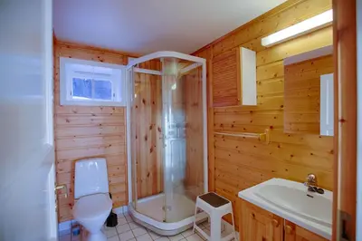 a bathroom with a shower and a toilet and a sink at Steps From The Slopes With Stunning Views! in Beitostøl