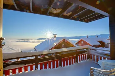 a balcony with snow on the roof of a house at Steps From The Slopes With Stunning Views! in Beitostøl