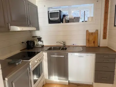 a small kitchen with a sink and a stove at Steps From The Slopes With Stunning Views! in Beitostøl