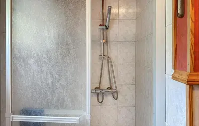 a shower with a glass door in a bathroom at 3 Bedroom Nice Home In Florø in Florø