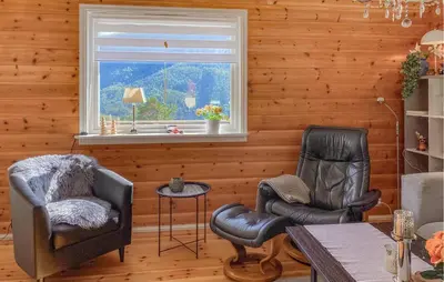 two chairs and a table in a room with a window at 3 Bedroom Nice Home In Florø in Florø