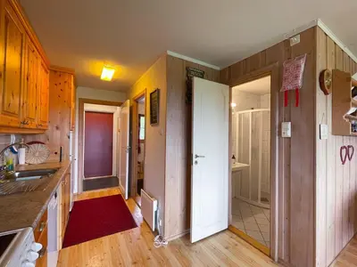 a kitchen with wooden walls and wooden floors at Perfect Retreat for Small Families in Beitostøl