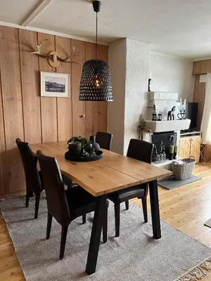 a dining room with a wooden table and chairs at Perfect Retreat for Small Families in Beitostøl