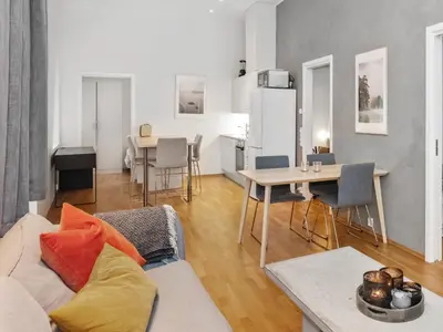 a living room with a couch and a table at Modern Apartment with Rooftop Terrace and Stunning Views in Bergen