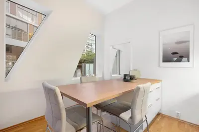 a dining room with a wooden table and chairs at Modern Apartment with Rooftop Terrace and Stunning Views in Bergen