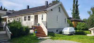 a small white house with a porch and stairs at Dalgårdveien 5 in Trondheim