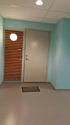 an empty room with a door and a window at Leilighet ved City Lade in Trondheim