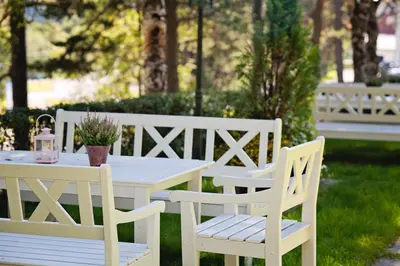 a white picnic table and chairs in a yard at Orkla Gjestebolig in Løkken