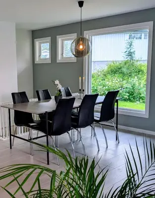 a dining room with a table and chairs at Fjellhagen - Geirangerfjord view in Hellesylt