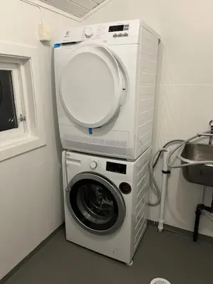 a washing machine in a bathroom next to a sink at Fjellhagen - Geirangerfjord view in Hellesylt