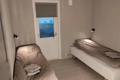 a living room with two beds and a window at Fjellhagen - Geirangerfjord view in Hellesylt