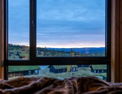 a window in a bedroom looking out at a view at Skistadion Hafjell in Hafjell