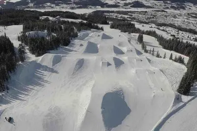 a snow covered mountain with a ski slope at Skistadion Hafjell in Hafjell