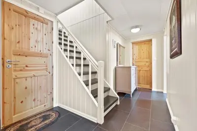 a hallway with a staircase in a house at Luksuriøs enebolig ved Granåsen til Ski-VM 2025 in Trondheim
