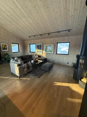 a living room with a couch and a table at Ny hytte i vakre Oppdal, Norge in Fagerhaug