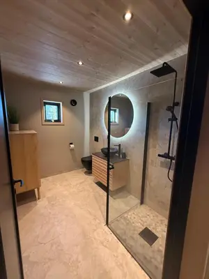 a bathroom with a shower and a mirror at Ny hytte i vakre Oppdal, Norge in Fagerhaug