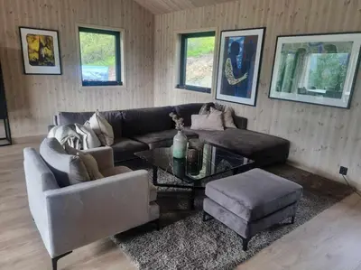 a living room with a couch and a table at Ny hytte i vakre Oppdal, Norge in Fagerhaug