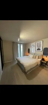 a large bedroom with a large bed and a window at Rekkehus til SKI-VM in Lund