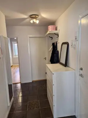 a bathroom with a mirror and a white cabinet at Central and cosy apartment in Trondheim, Free parkingspot in Trondheim