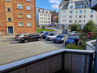 a group of cars parked in a parking lot at Central and cosy apartment in Trondheim, Free parkingspot in Trondheim