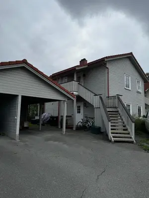 a house with a garage and a staircase next to it at Big 2 bedrooms apartment 10 min from Granåsen, VM2025 in Trondheim