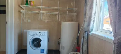 a laundry room with a washing machine and a window at Trysil sentrum leilighet in Trysil