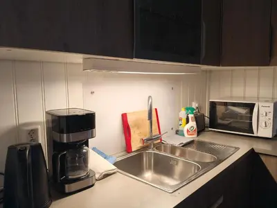 a kitchen counter with a sink and a coffee maker at Trysil sentrum leilighet in Trysil