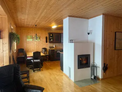 a living room with a fireplace and a kitchen at Cozy 3-Bedroom Apartment Near Beitostølen Ski in Beitostøl