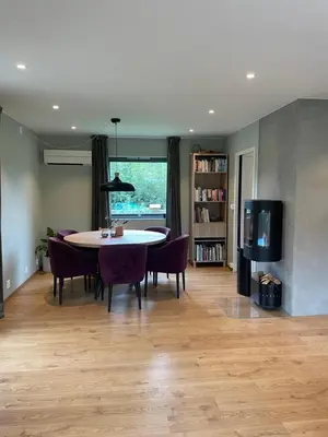 a dining room with a table and chairs and a tv at Presthusvegen in Trondheim