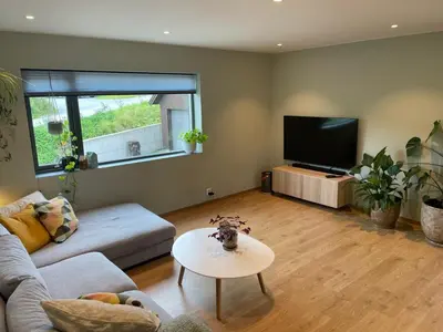 a living room with a couch and a flat screen tv at Presthusvegen in Trondheim