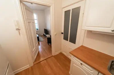 a kitchen with a door leading to a living room at Leilighet i Ålesund Sentrum in Ålesund
