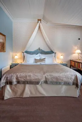 a bedroom with a large bed with a canopy at Jervell 2 BnB in Ålesund