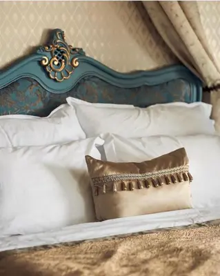a bed with white pillows and a pillow on it at Jervell 2 BnB in Ålesund