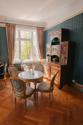 a dining room with a table and chairs and a window at Jervell 2 BnB in Ålesund