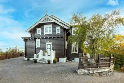 a house with a wooden fence in front of it at Jervell 2 BnB in Ålesund