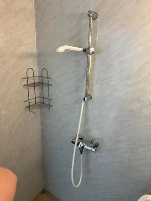 a shower with a shower head in a bathroom at Damehuset in Sæbø