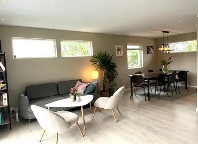 a living room with a couch and chairs and a table at House close to World cup Trondheim 2025 in Trondheim