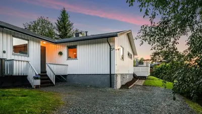 a white house with a driveway at House close to World cup Trondheim 2025 in Trondheim